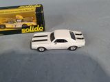 a toy car that is sitting next to a box