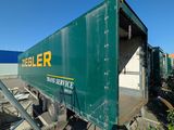 a green box truck that is parked in a lot