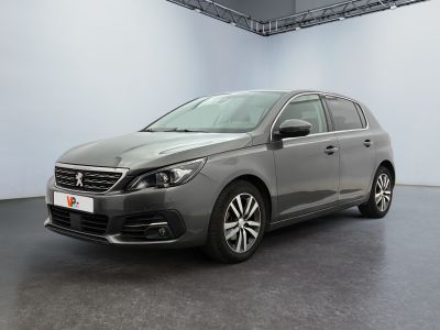 the grey car is parked in a large room with white walls