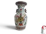 a white vase with a floral design on it