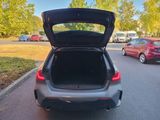 a car with its trunk open on the street