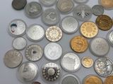 a lot of coins and a bottle of wine on the table