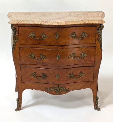 a small chest of drawers with marble top on it