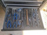 a drawer full of tools that are sitting on the floor