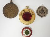 three medals and a medal are on a white surface