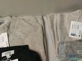 two pairs of pants and a t - shirt sitting on a table