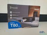 the box is open on a table with a remote control