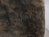 a large rock with writing on it sitting on a sidewalk