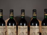 four bottles of wine are lined up on a table