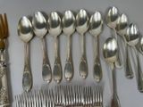 a lot of silver spoons and forks on the table
