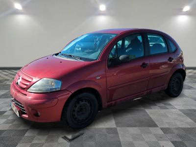 a picture of a red car parked in a garage