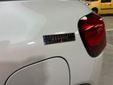 a sticker on the back of a white car