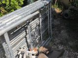 a metal fence that has a bunch of items on top of it