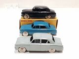 three toy cars that are sitting on top of each other