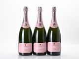three bottles of champagne sitting on top of a white table