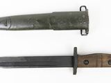 an old knife with a wooden handle sitting next to a smaller knife
