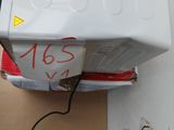 a white refrigerator sitting on top of a box next to a blue bucket