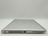 a close up of a laptop computer on a white surface