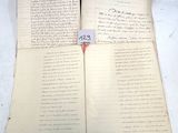 deux feuilles de papier usagé, couvertes d'écriture, posées sur une table
