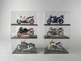 four different models of motorcycles in a display case