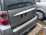 a silver car parked in a parking lot with other cars in the background