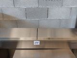 two stainless steel tables and a microwave in the kitchen