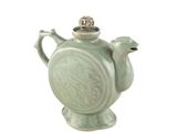a green tea pot with a bird on it