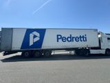 the semi truck is parked on the side of the road