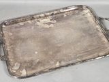 a silver tray with handles on a table