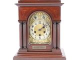a wooden clock that is sitting on a white surface