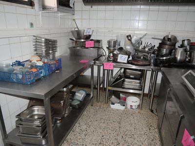 many pots and pans on the counter in the kitchen