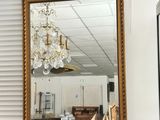 a mirror that is sitting on a dresser in a room