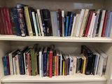 a book shelf with many books on it in a room