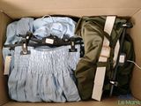 a box with clothes and a pair of scissors in it