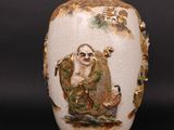 a white vase with a picture of a man on it
