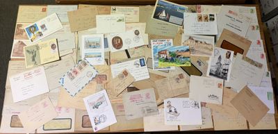 a suitcase full of letters and postcards on the floor