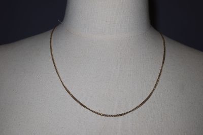 a close up of a mannequin torso with a chain on it