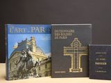 two books are sitting on a table next to a cross and a book
