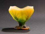a yellow and green vase sitting on a table
