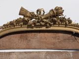 a gold frame with a clock on top of it