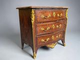 an antique chest of drawers with gold decoration on the drawers