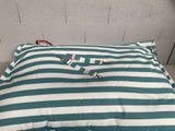 a blue and white striped pillow on the floor