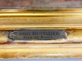 une image montrant un gros plan d'un cadre doré sur lequel est apposée une plaque