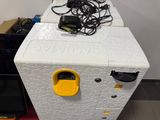 a white refrigerator with a yellow door and some wires on top of it