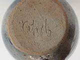 a close up of a vase with a name written on it