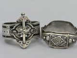 pair of silver rings with crosses and crosses on them