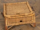 a small wicker table on a wooden floor