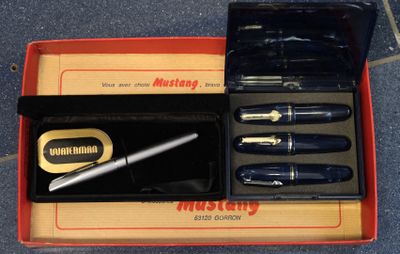 a box with a pen, a pen, and a pen in it