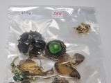 a bag of assorted jewelry on a white surface