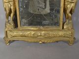 a gold frame with a picture of a man and a woman on it